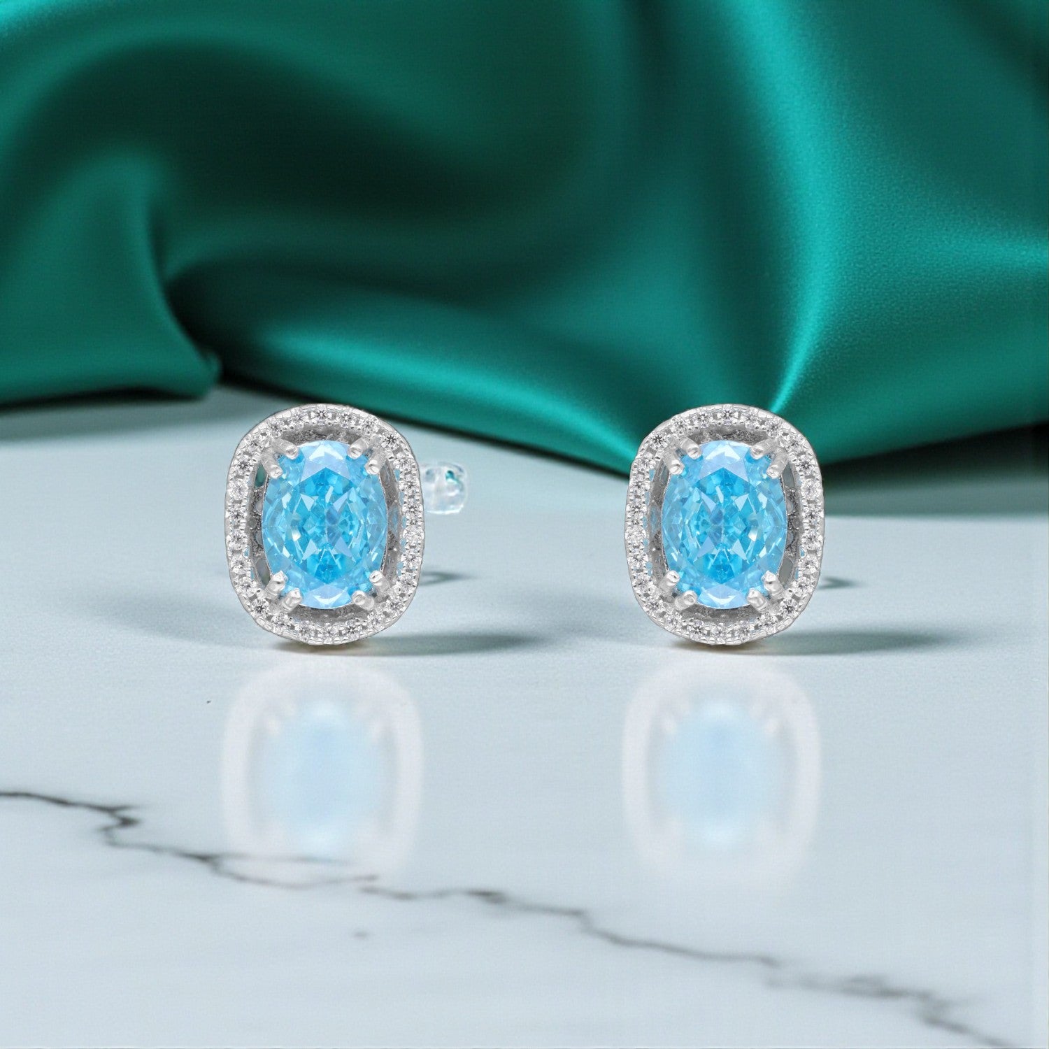 Sterling Silver Blue Oval Halo Stud Earrings | SKU : 0005476671