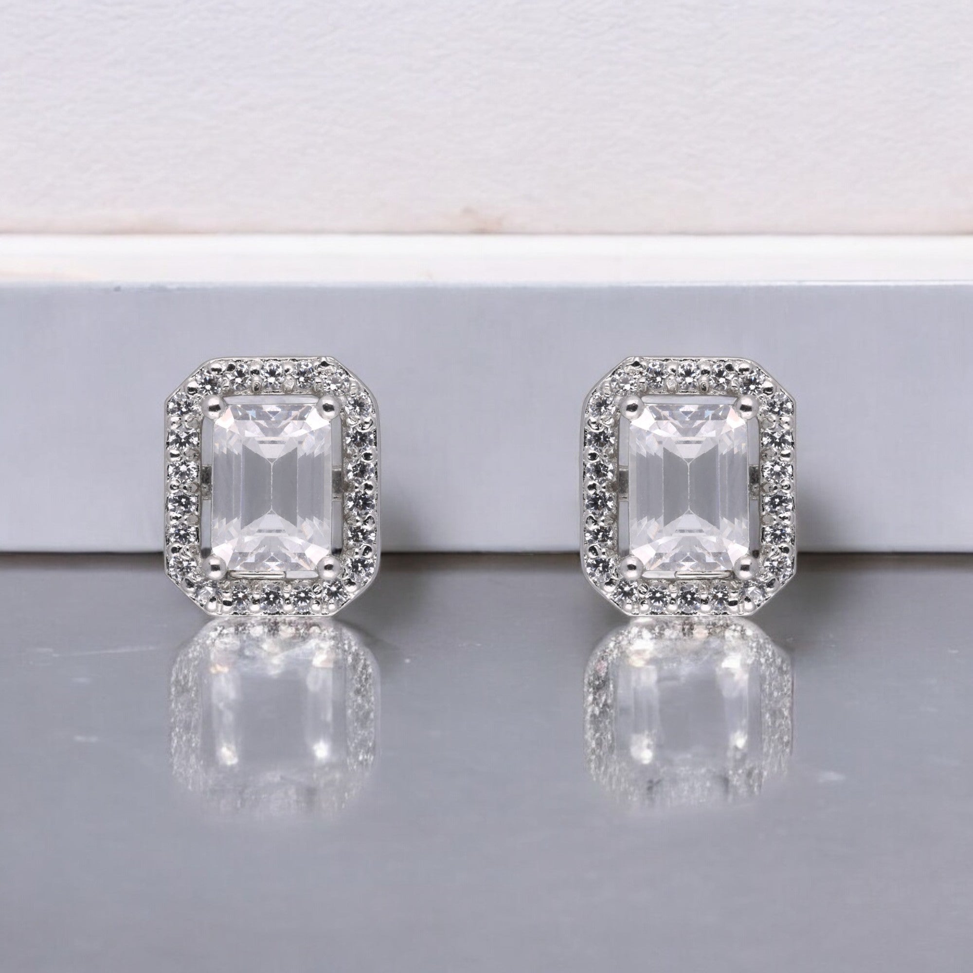 Regal Brilliance: Emerald-Cut White Gemstone Halo Stud Earrings in Sterling Silver | SKU : 0003535127, 0021327148, 0021327155